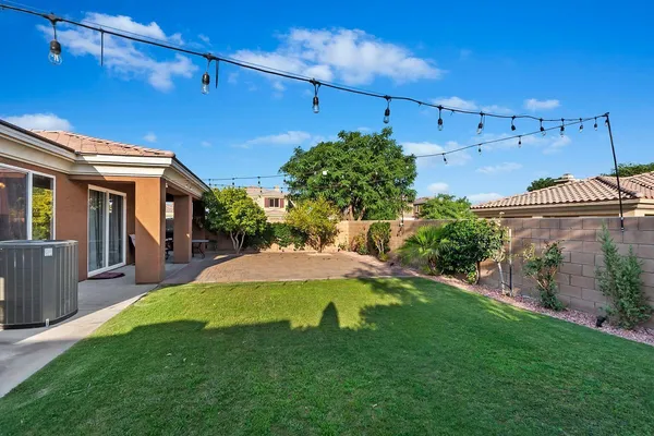 a view of a backyard with plants and a patio