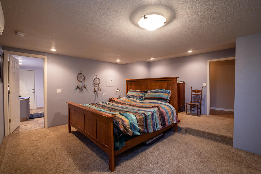 4579 Winnetka Road White City, OR 97503 - Photo 19 of 28 a bedroom with a bed and a large mirror
