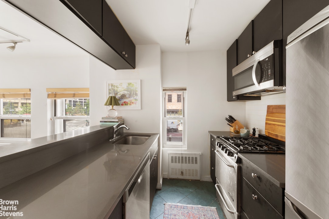 350 West 14th Street, Unit 2D Manhattan, NY 10014 - Photo 2 of 6 a kitchen with stainless steel appliances a sink stove and microwave