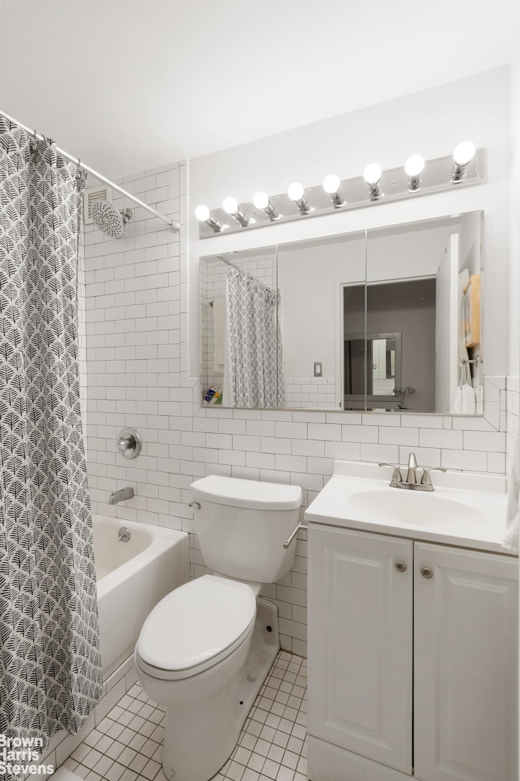 350 West 14th Street, Unit 2D Manhattan, NY 10014 - Photo 4 of 6 a bathroom with a sink a toilet and shower