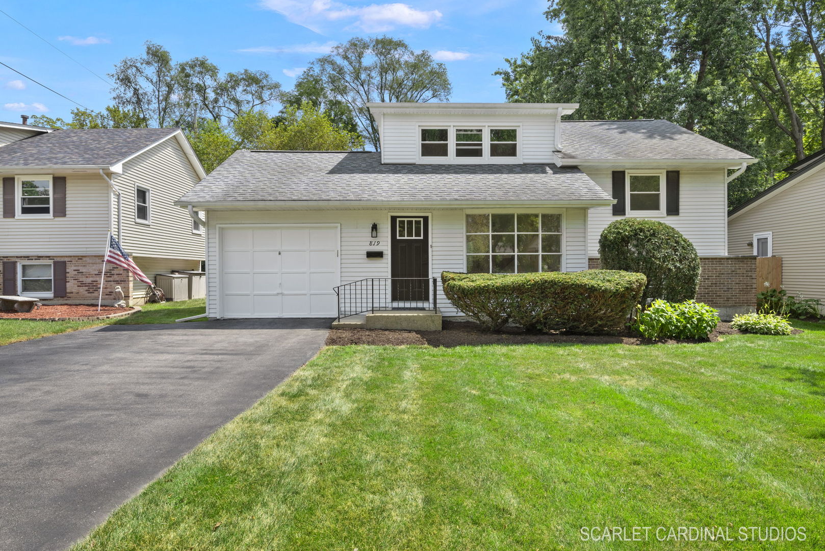 819 Delles Road Wheaton, IL 60189 - Photo 1 of 28 a front view of a house with a yard and garage