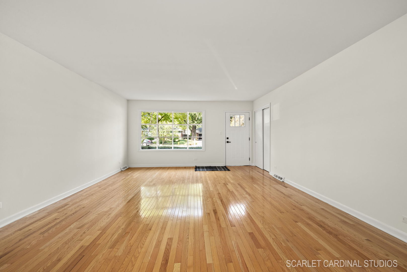 819 Delles Road Wheaton, IL 60189 - Photo 3 of 28 an empty room with wooden floor and windows