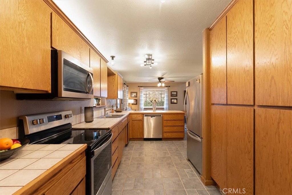 1533 West A Barr Road Mount Shasta, CA 96067 - Photo 12 of 38 a kitchen with stainless steel appliances kitchen island granite countertop a refrigerator a stove top oven a sink and dishwasher