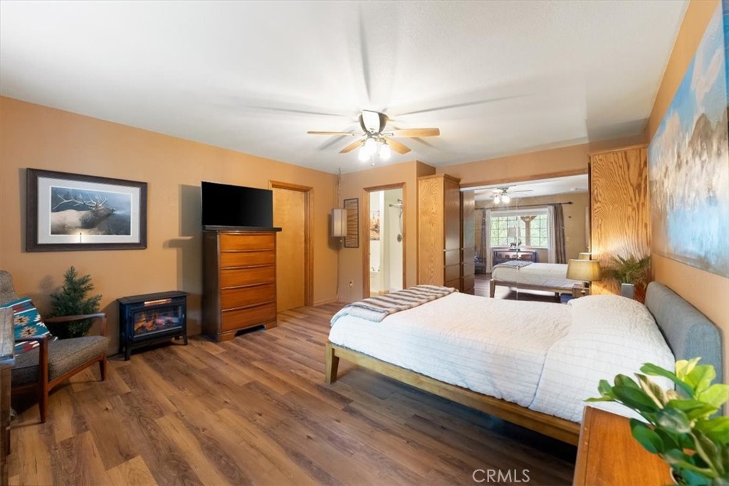 1533 West A Barr Road Mount Shasta, CA 96067 - Photo 13 of 38 a bedroom with a bed a dresser and a chandelier