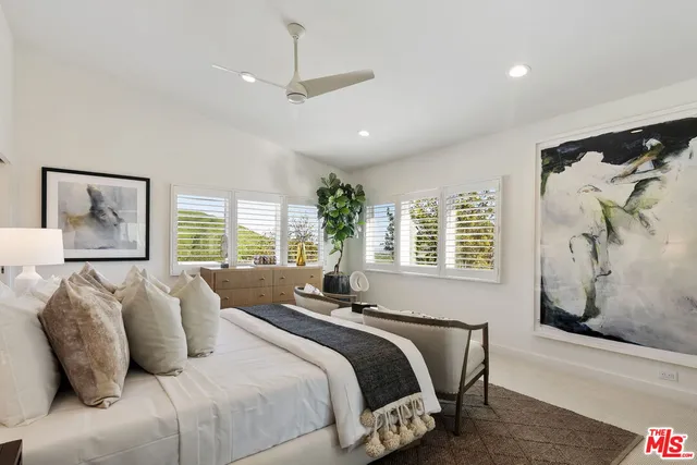 a bedroom with a bed and a desk