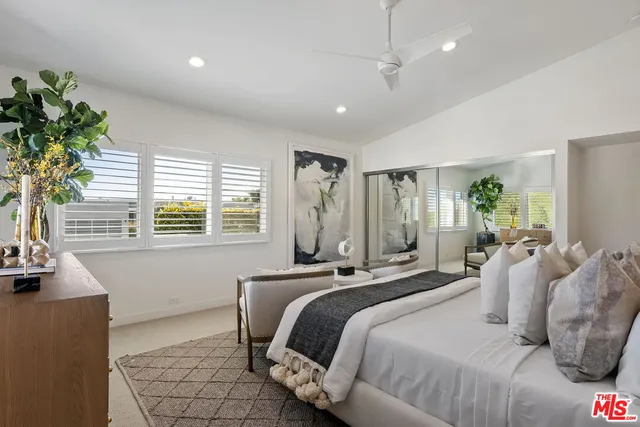 a table and chair in a room next to a window