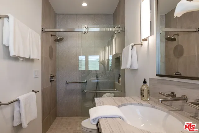 a front view of a house with swimming pool having outdoor seating