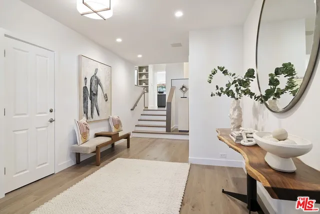 a living room with furniture a fireplace and a potted plant