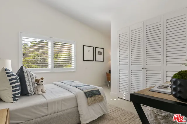 a view of patio with table and chairs potted plants with wooden floor