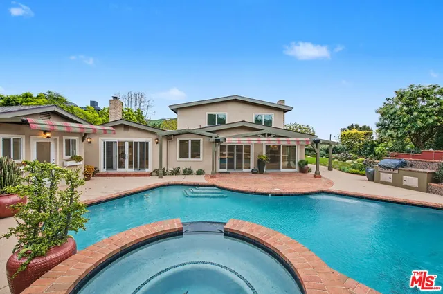 an aerial view of residential houses with outdoor space and parking