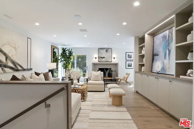 a living room with furniture and painting on the wall