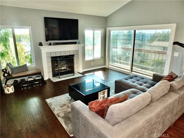 a living room with furniture flat screen tv and a fireplace