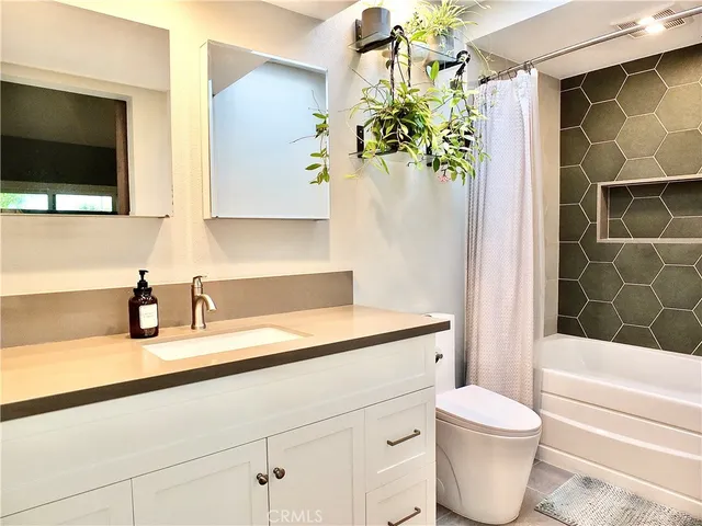 a bathroom with a bathtub and shower