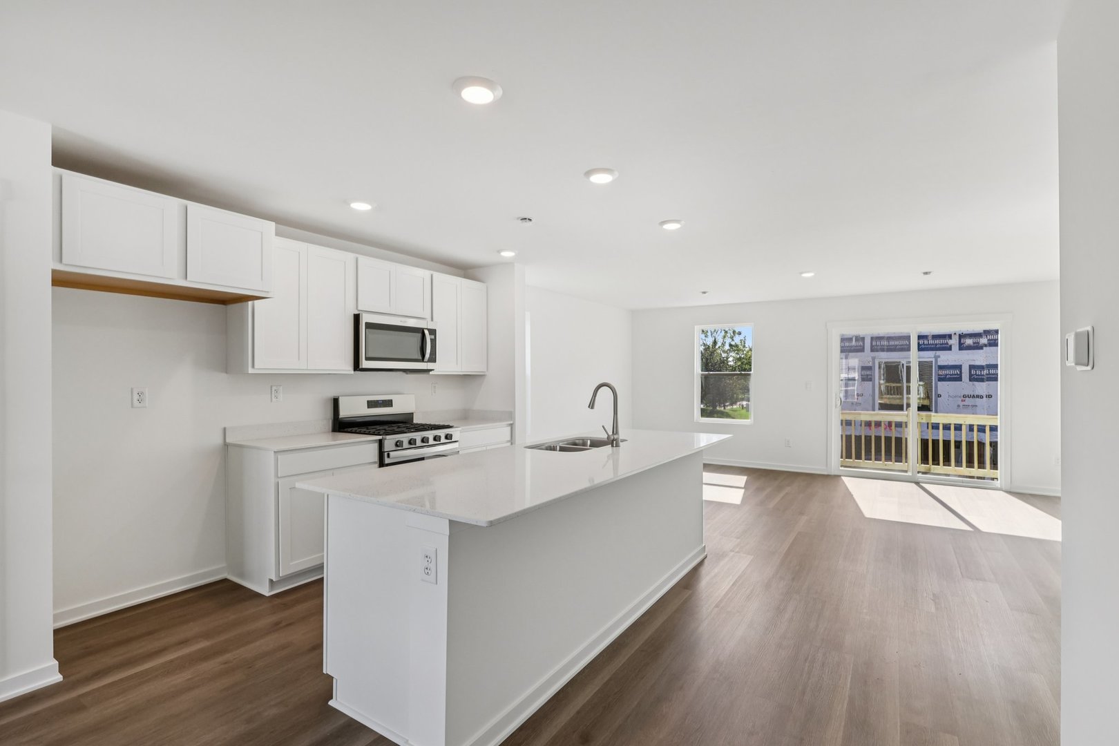 1435 Oakfield Lane Pingree Grove, IL 60140 - Photo 5 of 60 a kitchen with stainless steel appliances a sink dishwasher a stove top oven a refrigerator with wooden floors and cabinets