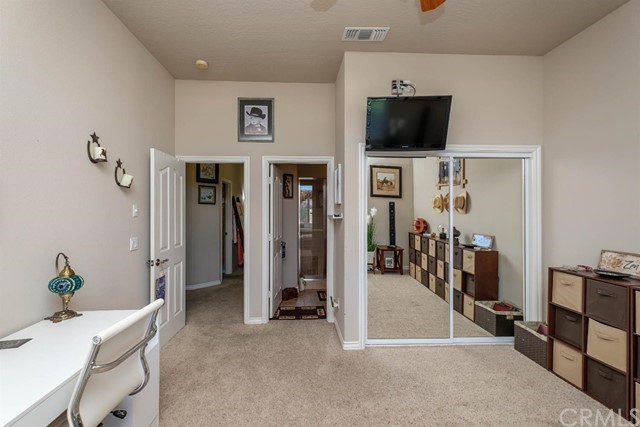 19286 Kanbridge Street Apple Valley, CA 92308 - Photo 14 of 37 a view of a livingroom with furniture and a flat screen tv