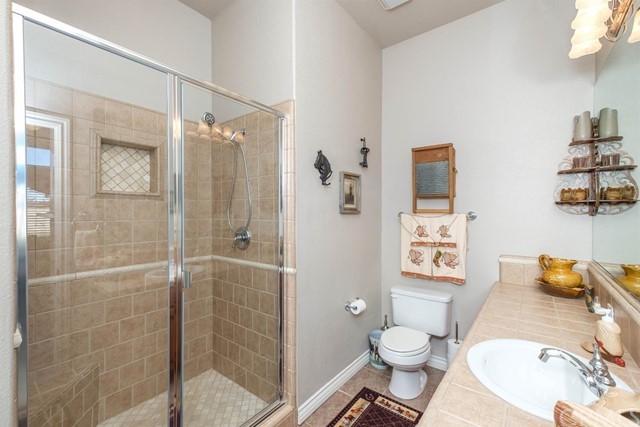 19286 Kanbridge Street Apple Valley, CA 92308 - Photo 16 of 37 a bathroom with a granite countertop toilet sink and shower