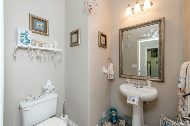 19286 Kanbridge Street Apple Valley, CA 92308 - Photo 18 of 37 a bathroom with a sink mirror and toilet