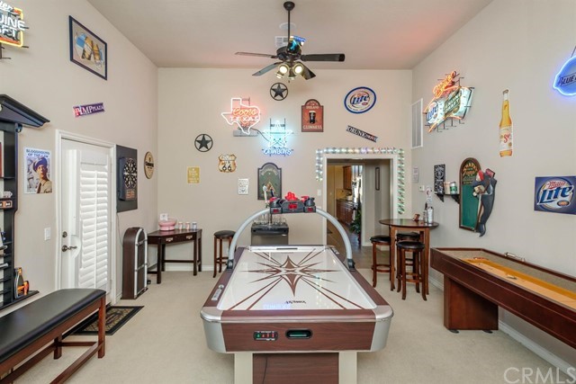 19286 Kanbridge Street Apple Valley, CA 92308 - Photo 19 of 37 a living room with furniture a chandelier and a fireplace