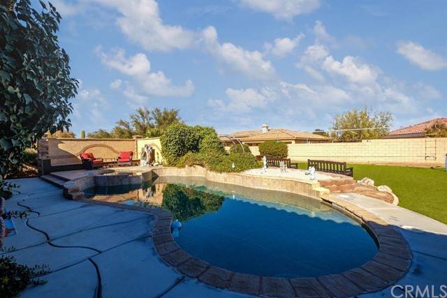 19286 Kanbridge Street Apple Valley, CA 92308 - Photo 31 of 37 a view of a swimming pool with an outdoor space and seating area