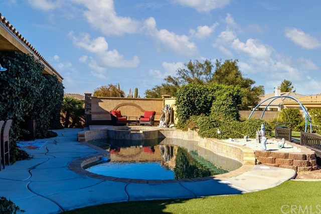 19286 Kanbridge Street Apple Valley, CA 92308 - Photo 33 of 37 a view of a swimming pool with an outdoor seating