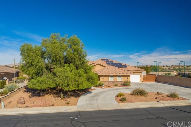 19286 Kanbridge Street Apple Valley, CA 92308 - Photo 35 of 37 a front view of a house with a yard