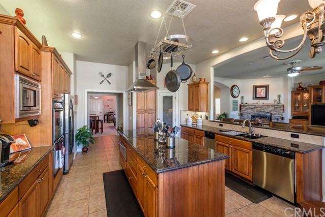 19286 Kanbridge Street Apple Valley, CA 92308 - Photo 5 of 37 a kitchen with stainless steel appliances granite countertop a sink a stove and a wooden floors