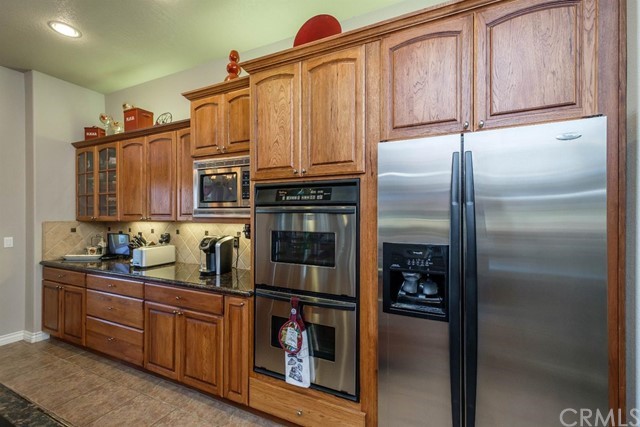 19286 Kanbridge Street Apple Valley, CA 92308 - Photo 6 of 37 a kitchen with stainless steel appliances granite countertop a refrigerator and a sink