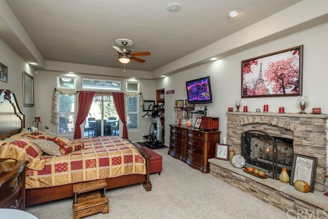 19286 Kanbridge Street Apple Valley, CA 92308 - Photo 7 of 37 a bedroom with a bed and a fireplace