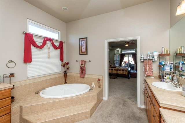 19286 Kanbridge Street Apple Valley, CA 92308 - Photo 10 of 37 a bathroom with a sink tub and a mirror