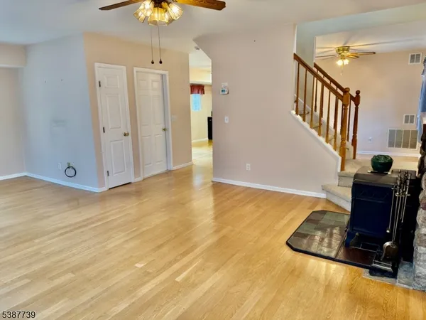 a view of a room with wooden floor