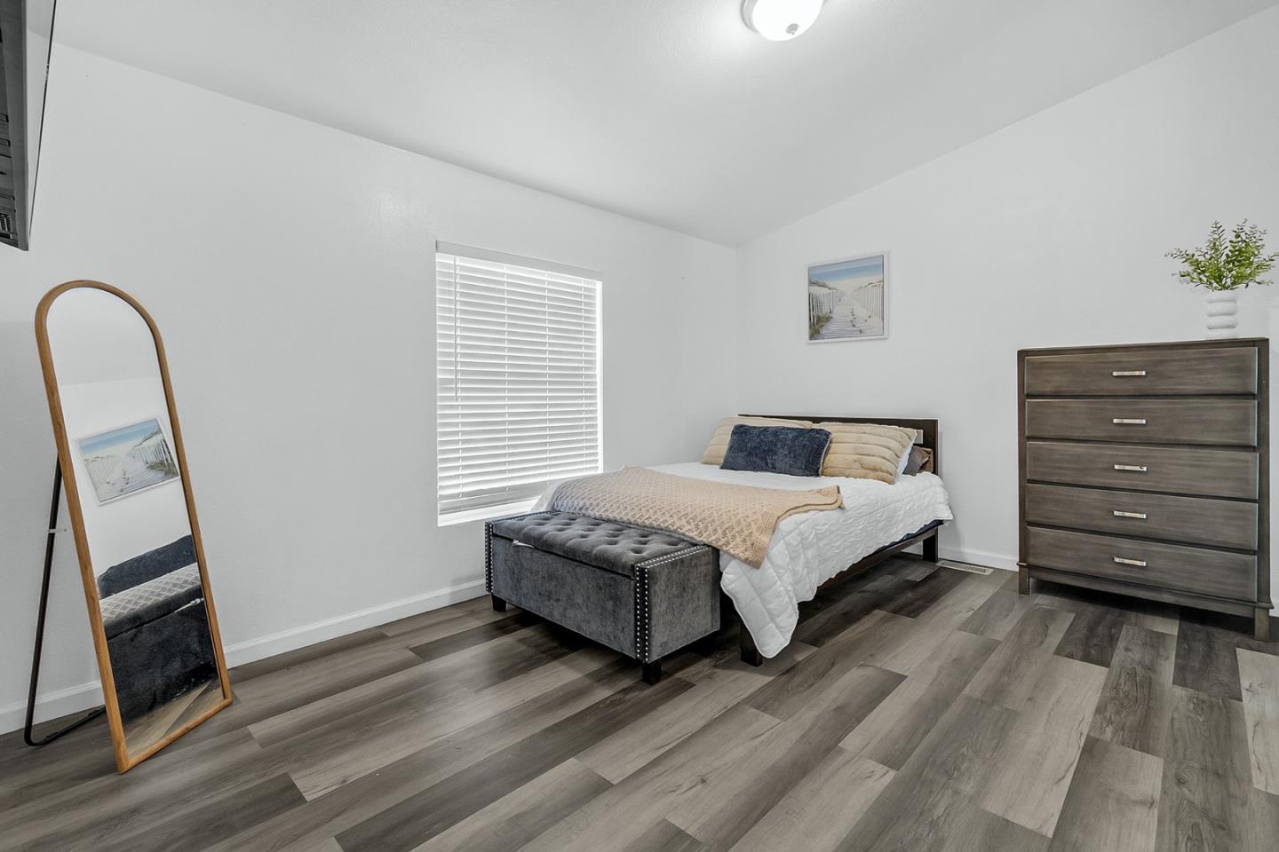 1900 Highway 1, Unit 62 Moss Landing, CA 95039 - Photo 12 of 21 a bedroom with a bed and a mirror