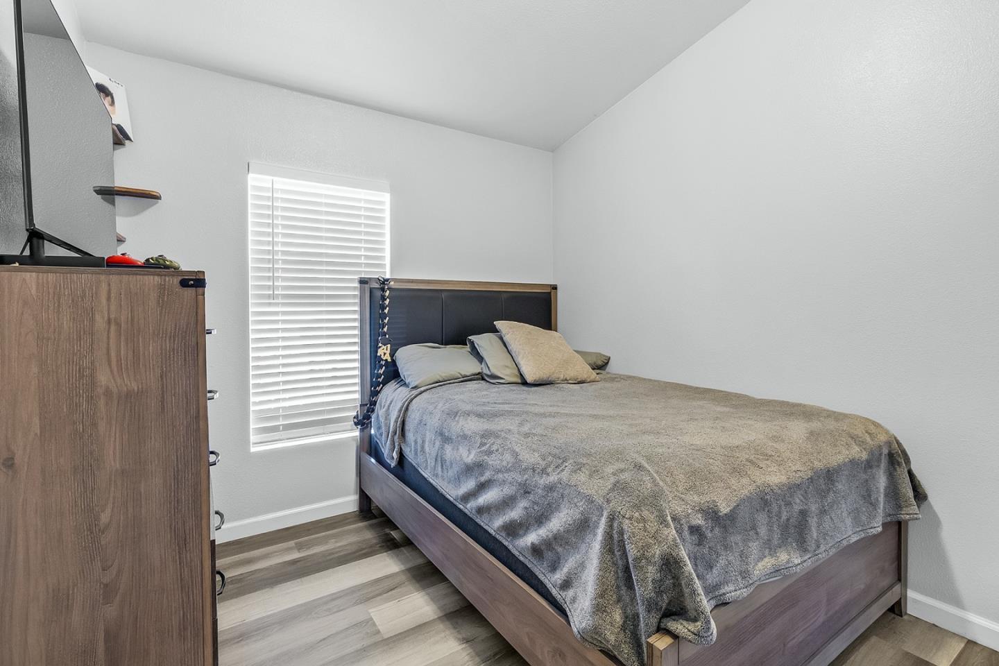 1900 Highway 1, Unit 62 Moss Landing, CA 95039 - Photo 17 of 21 a bedroom with a bed and a window