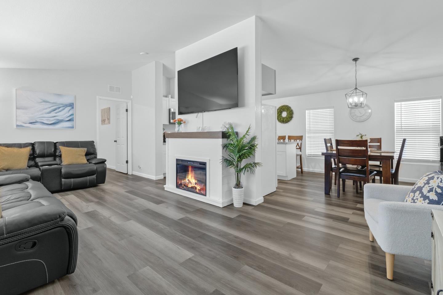 1900 Highway 1, Unit 62 Moss Landing, CA 95039 - Photo 5 of 21 a living room with furniture a fireplace a flat screen tv and kitchen view