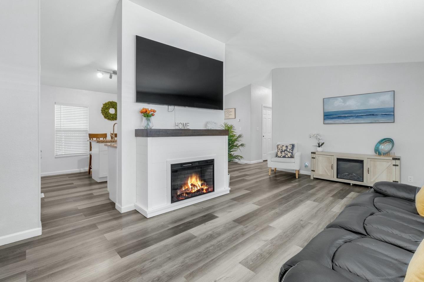 1900 Highway 1, Unit 62 Moss Landing, CA 95039 - Photo 7 of 21 a living room with furniture a flat screen tv and a fireplace