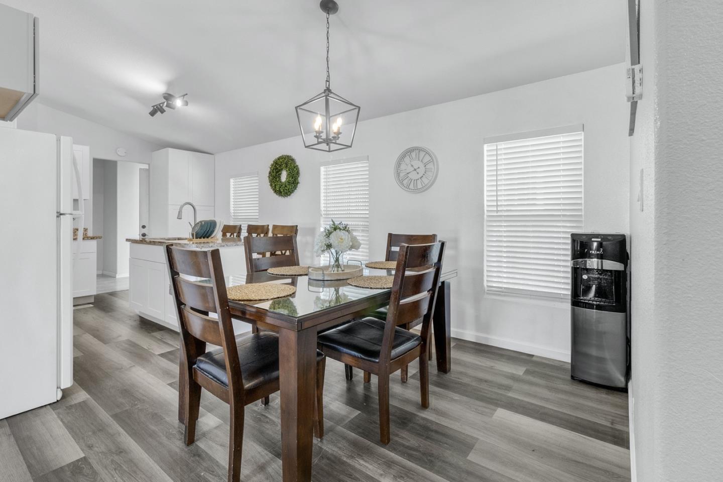 1900 Highway 1, Unit 62 Moss Landing, CA 95039 - Photo 10 of 21 a view of a dining room with furniture a chandelier and wooden floor