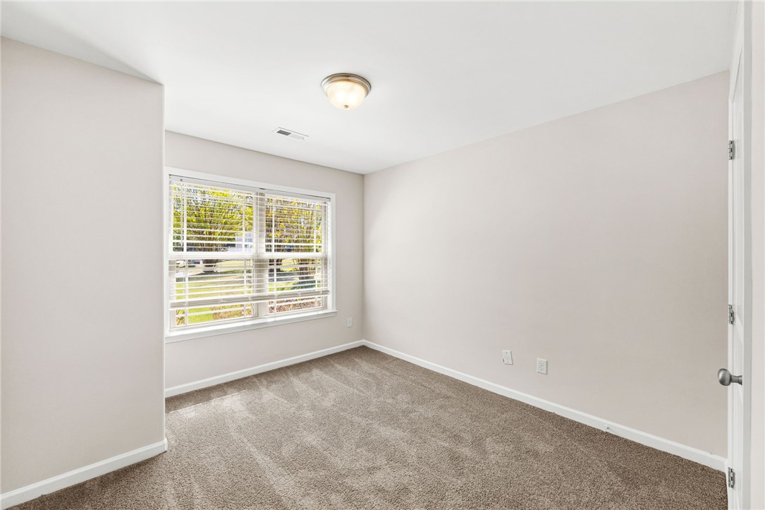 113 Crofton Court Easley, SC 29642 - Photo 17 of 33 This airy room offers comfort and versatility, featuring soft carpet and ample natural light.