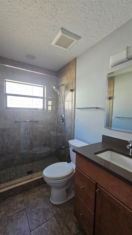 882 Lucas Lane Oldsmar, FL 34677 - Photo 16 of 27 a bathroom with a sink a toilet a mirror and shower