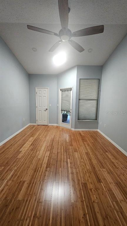 882 Lucas Lane Oldsmar, FL 34677 - Photo 18 of 27 an empty room with wooden floor and windows