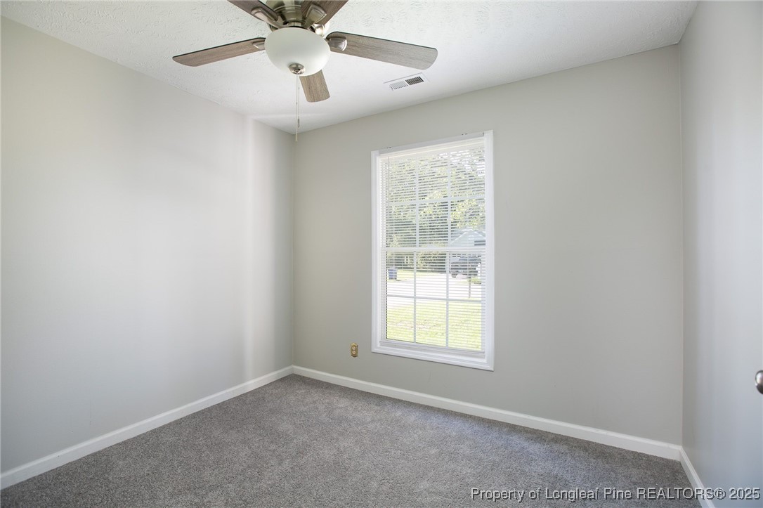 163 Independence Drive Raeford, NC 28376 - Photo 6 of 10 an empty room with a window and a fan