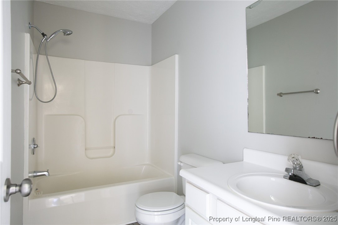 163 Independence Drive Raeford, NC 28376 - Photo 7 of 10 a bathroom with a sink a toilet and shower