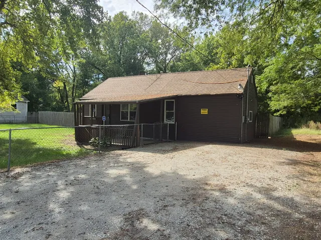 a house with trees in the background