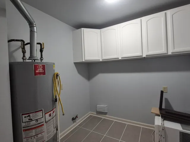 a view of a storage and utility room with closet