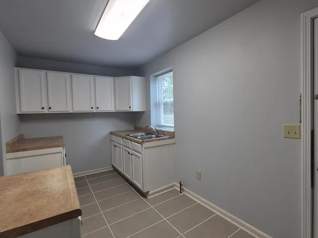 a kitchen with granite countertop a sink and a stove top oven