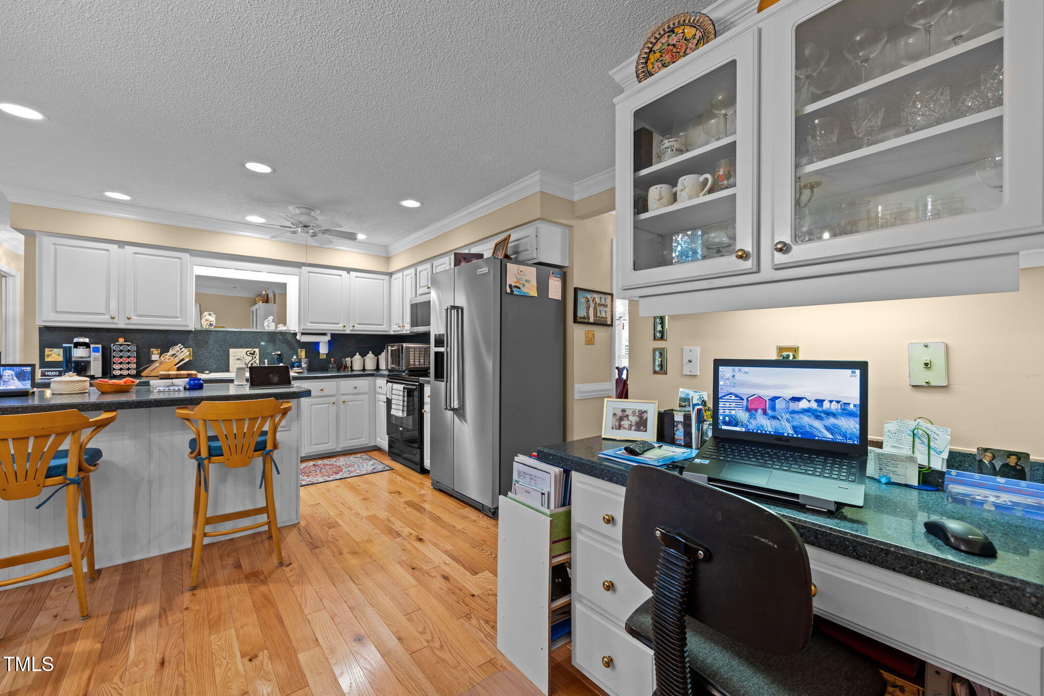 8516 Wheeling Drive Raleigh, NC 27615 - Photo 11 of 29 a living room with stainless steel appliances kitchen island granite countertop furniture and a kitchen view
