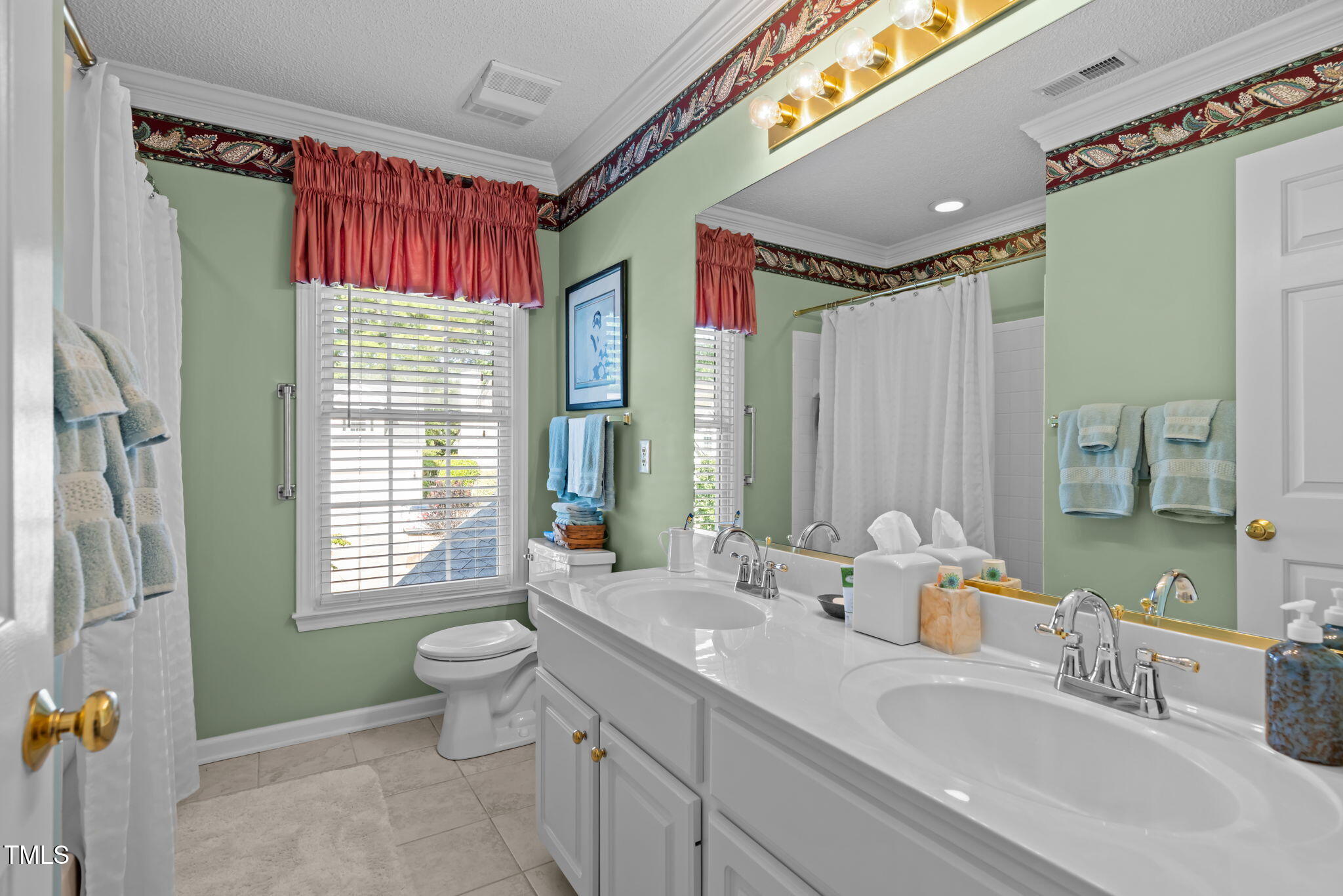 8516 Wheeling Drive Raleigh, NC 27615 - Photo 18 of 29 a bathroom with a toilet sink and mirror