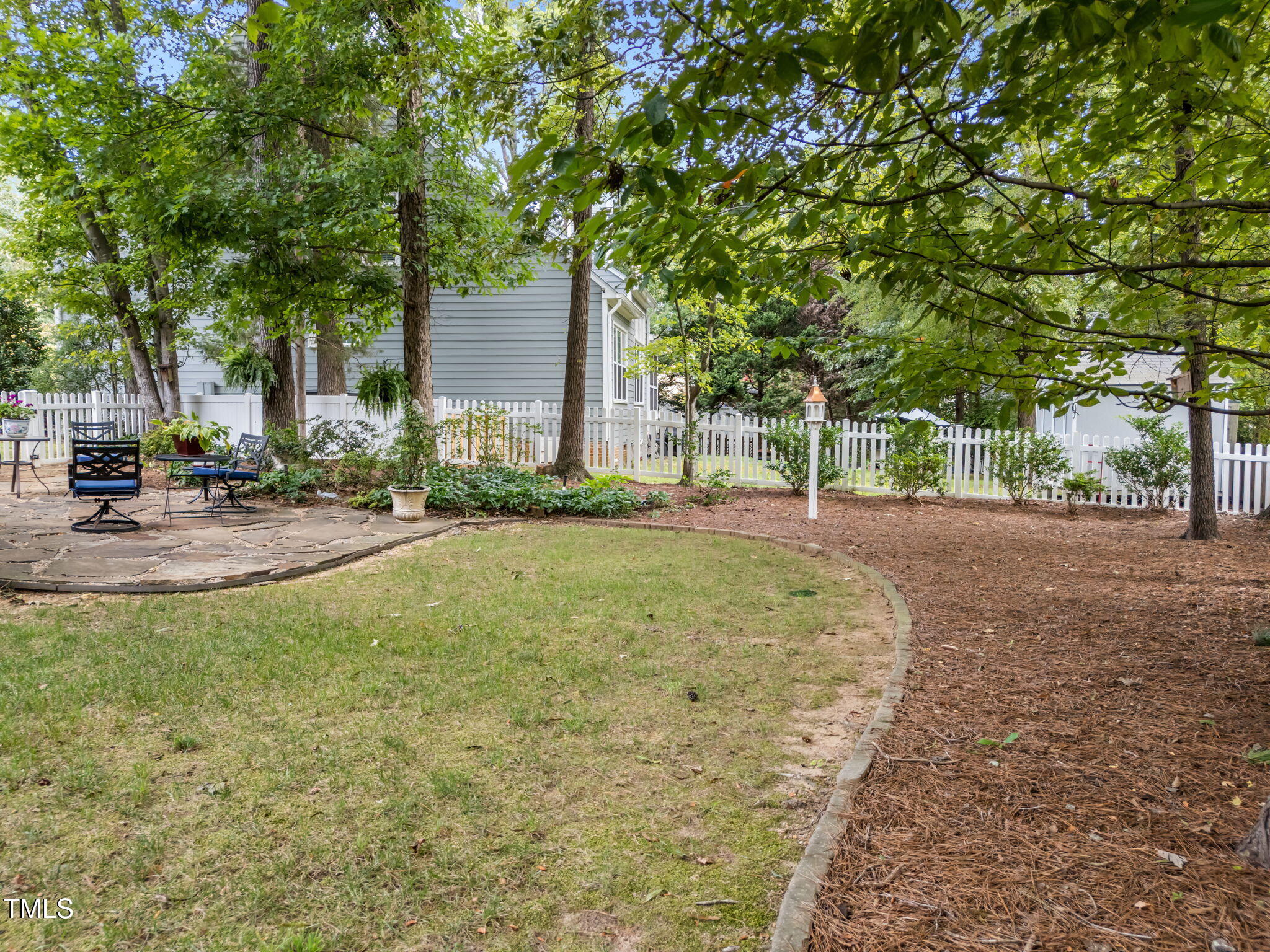 8516 Wheeling Drive Raleigh, NC 27615 - Photo 23 of 29 a backyard of a house with lots of green space and garden