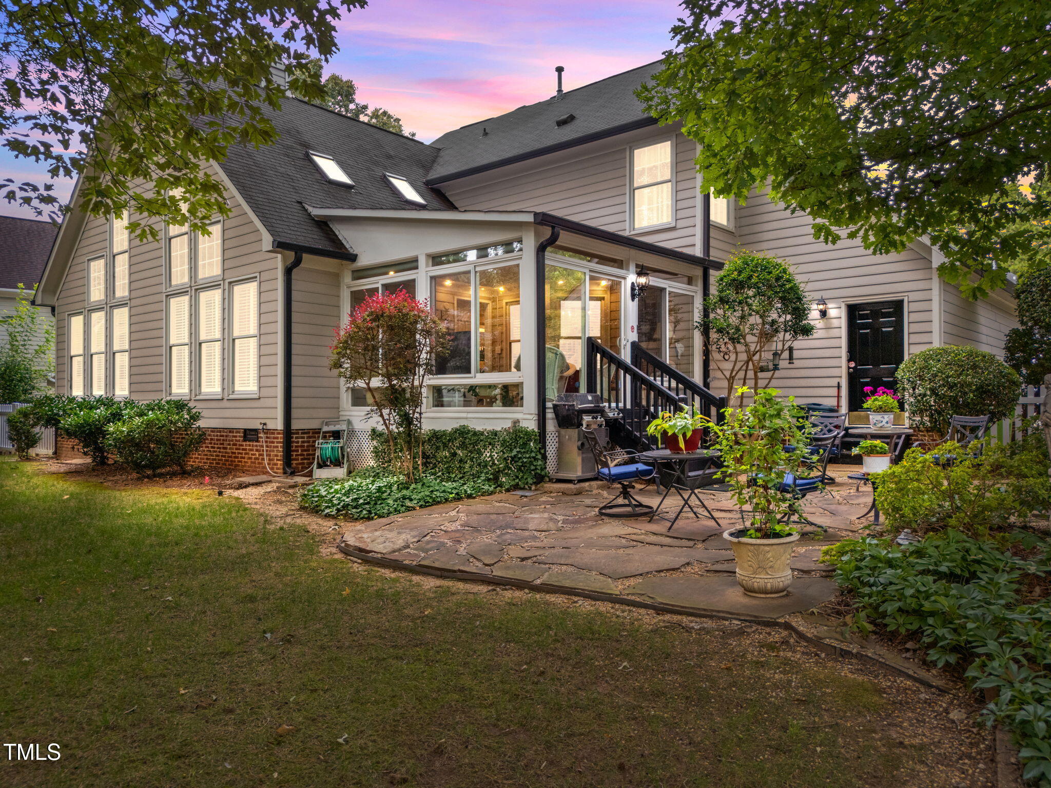 8516 Wheeling Drive Raleigh, NC 27615 - Photo 3 of 29 a view of a chair and table in backyard of the house