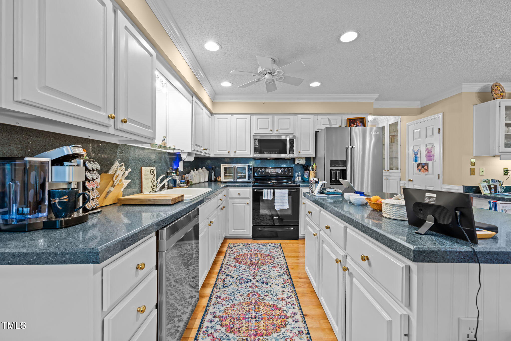 8516 Wheeling Drive Raleigh, NC 27615 - Photo 10 of 29 a kitchen with kitchen island granite countertop lots of counter top space