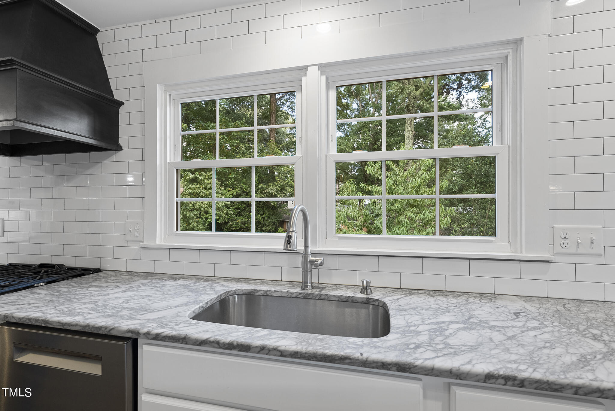 4900 Latimer Road Raleigh, NC 27609 - Photo 16 of 46 a kitchen with granite countertop a sink and a window
