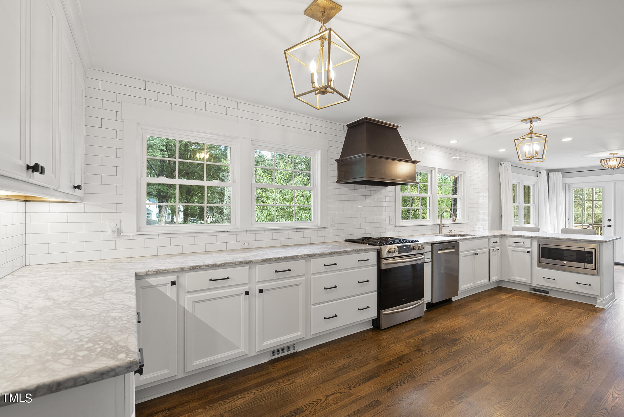 4900 Latimer Road Raleigh, NC 27609 - Photo 19 of 46 a kitchen with granite countertop a stove a sink a window and dining table